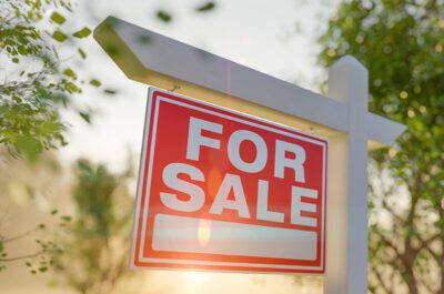 For Sale Real Estate Sign In Front of Property.