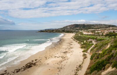 An expansive view of the white sands of Salt Creek Beach, waves crashing against the shore.