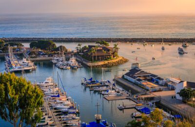 Sunset over luxury yachts and boats in Dana Point harbor, Orange county in Southern California