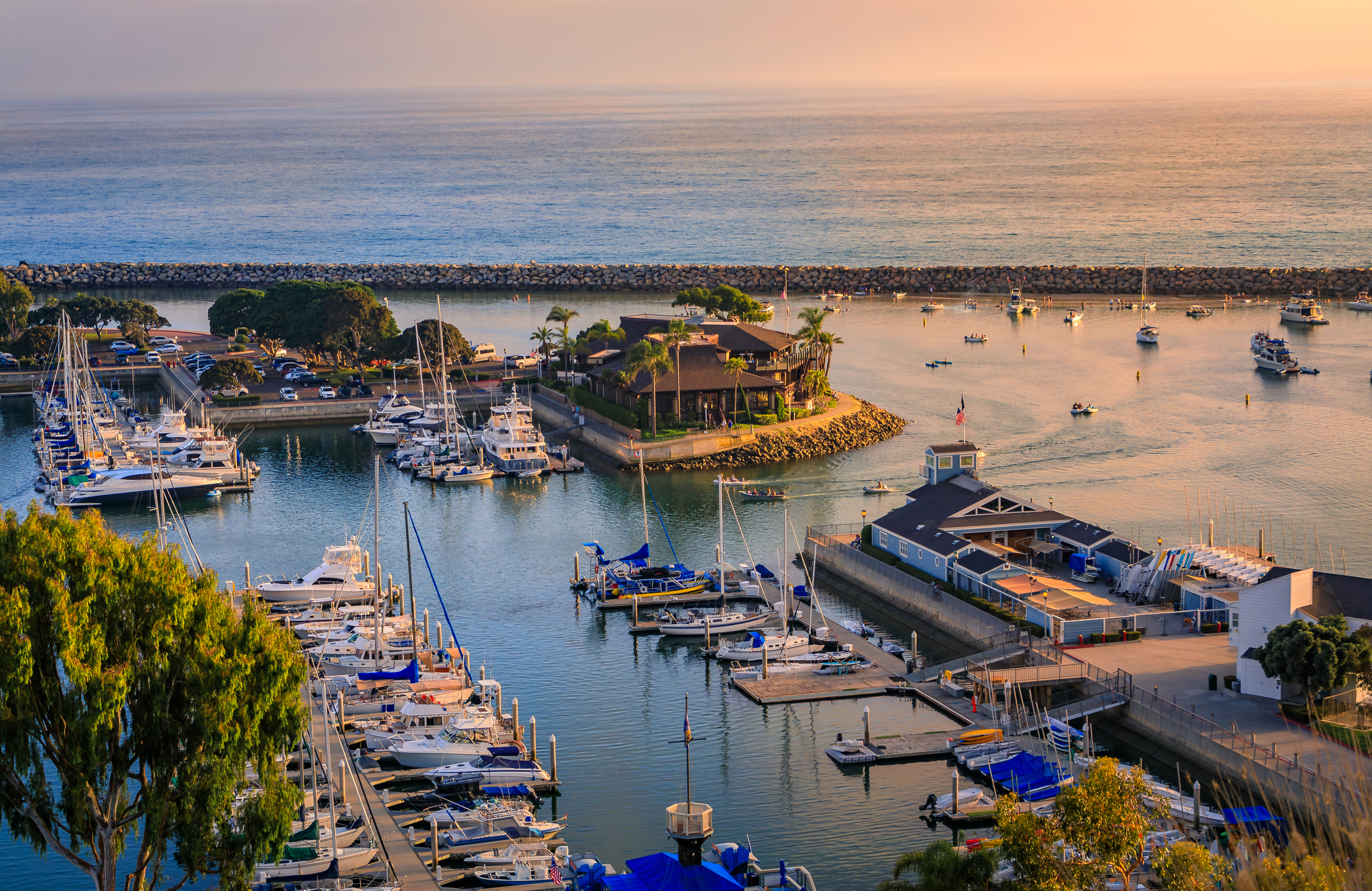 Sunset over luxury yachts and boats in Dana Point harbor, Orange county in Southern California