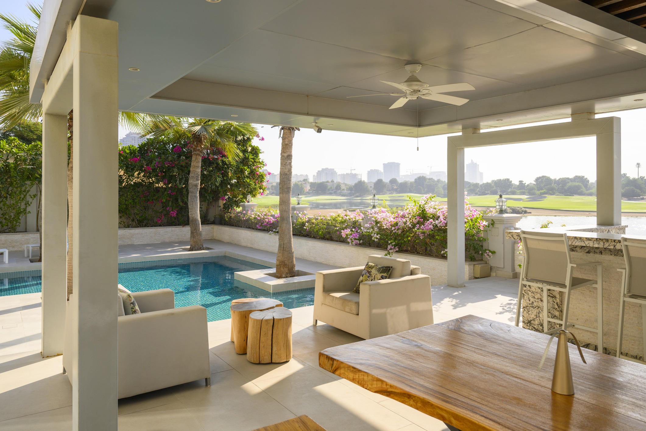 Luxurious villa patio with swimming pool and view on a golf course